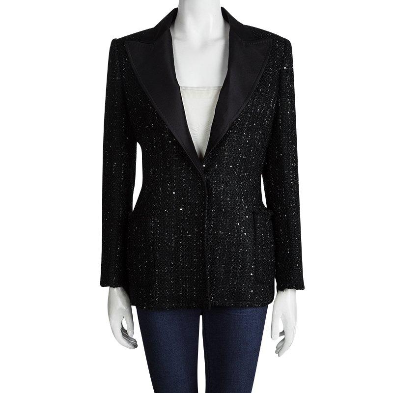 Lend a stylish edge to your executive wardrobe collection with this blazer from Carolina Herrera! The sleek black piece is embellished with sequins and feature edgy wide lapel. Crafted in quality tweed, the blazer houses smooth cotton lining. The