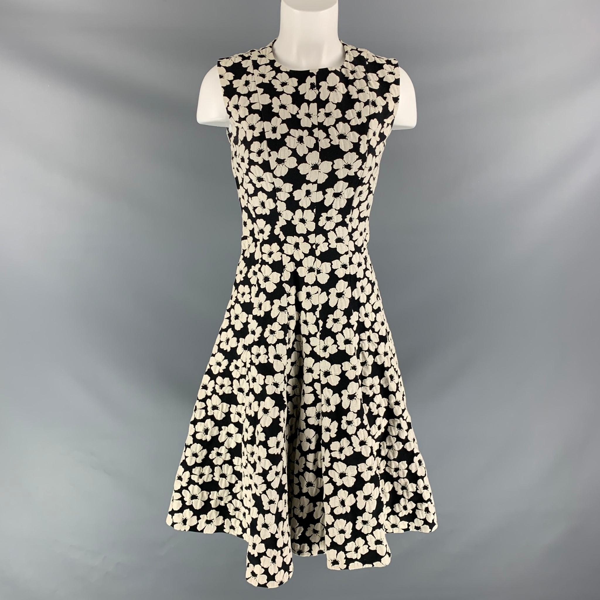 CH CAROLINA HERRERA  mid-calf dress comes in black and white floral cotton blend fabric features a full skirt. Made in Portugal.

Excellent Pre-Owned Condition.
Marked: Size tag removed.

Measurements:

Shoulder:13.5 in
Bust: 32 in
Waist: 26 in