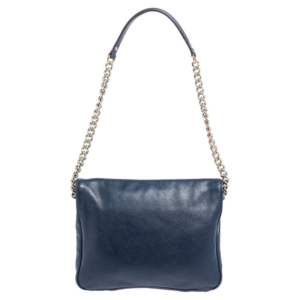 The house of Carolina Herrera has exclusively designed this elegant bag for you. It has been crafted from blue leather and adds a chic appeal to any ensemble. It has a front flap with the 'CH' logo that opens to a fabric-lined interior. It is
