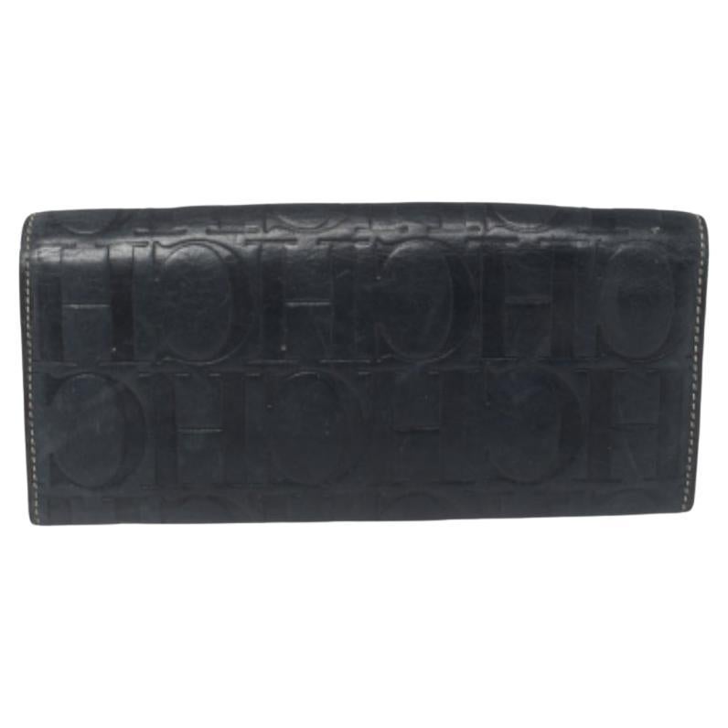 Basic essentials can be carried effortlessly in this Carolina Herrera flap wallet. Crafted from monogram leather, the durable wallet features multiple card slots, bill compartments, and a zip pocket.