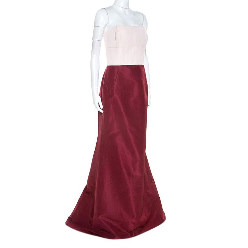 This adorable gown by Carolina Herrera is the perfect creation to match your elegant personality with grace and style. This masterpiece is tailored from silk. The amazing gown features a fitted bodice, an elaborate burgundy skirt for that standout