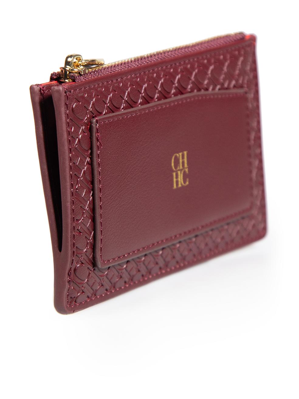 CONDITION is Very good. Minimal wear to the wallet is evident. Abrasion to one corner. Glue is visible on one side of the zipper compartment on this used Carolina Herrera designer resale item. This wallet comes with the original dust bag and box.
 