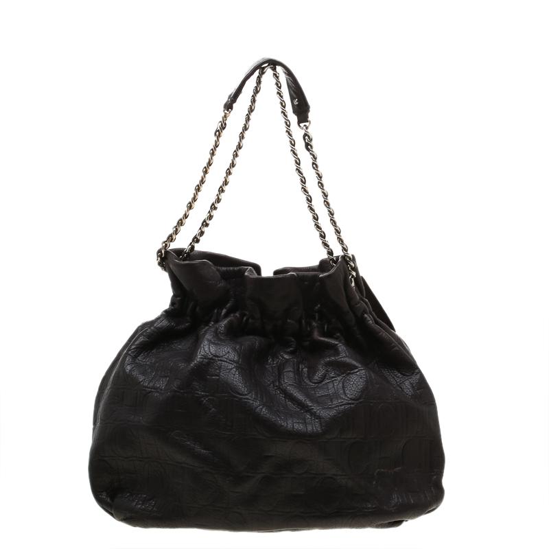Adorn this Bow Bucket bag from Carolina Herrera that is gorgeous and durable. The bag is crafted from Monogram leather and styled with a bow on the front. It features a chain and leather strap and a fabric interior sized to hold your