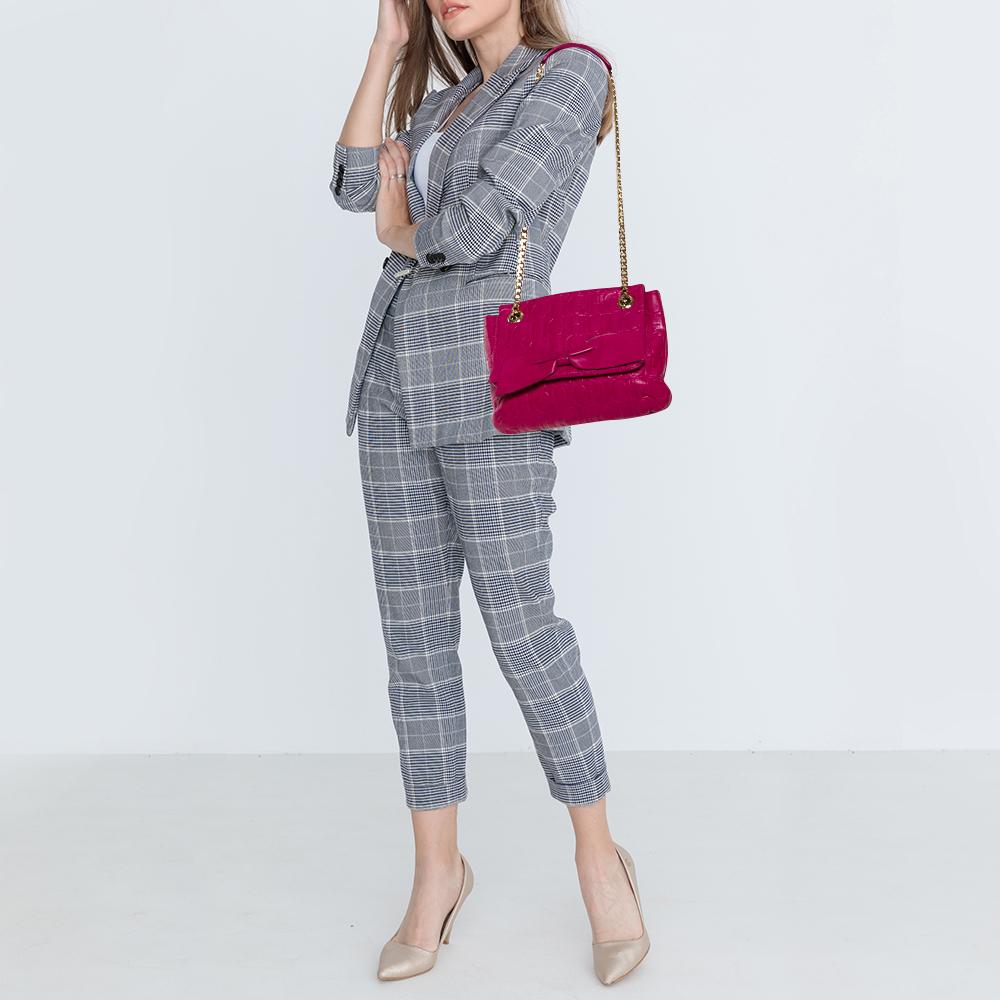 Shoulder bags as pretty as this one by Carolina Herrera are not creations you find every day. That's why this bag is worthy of a place in your closet. It has been crafted from monogram leather and styled with a bow-adorned flap that leads to a