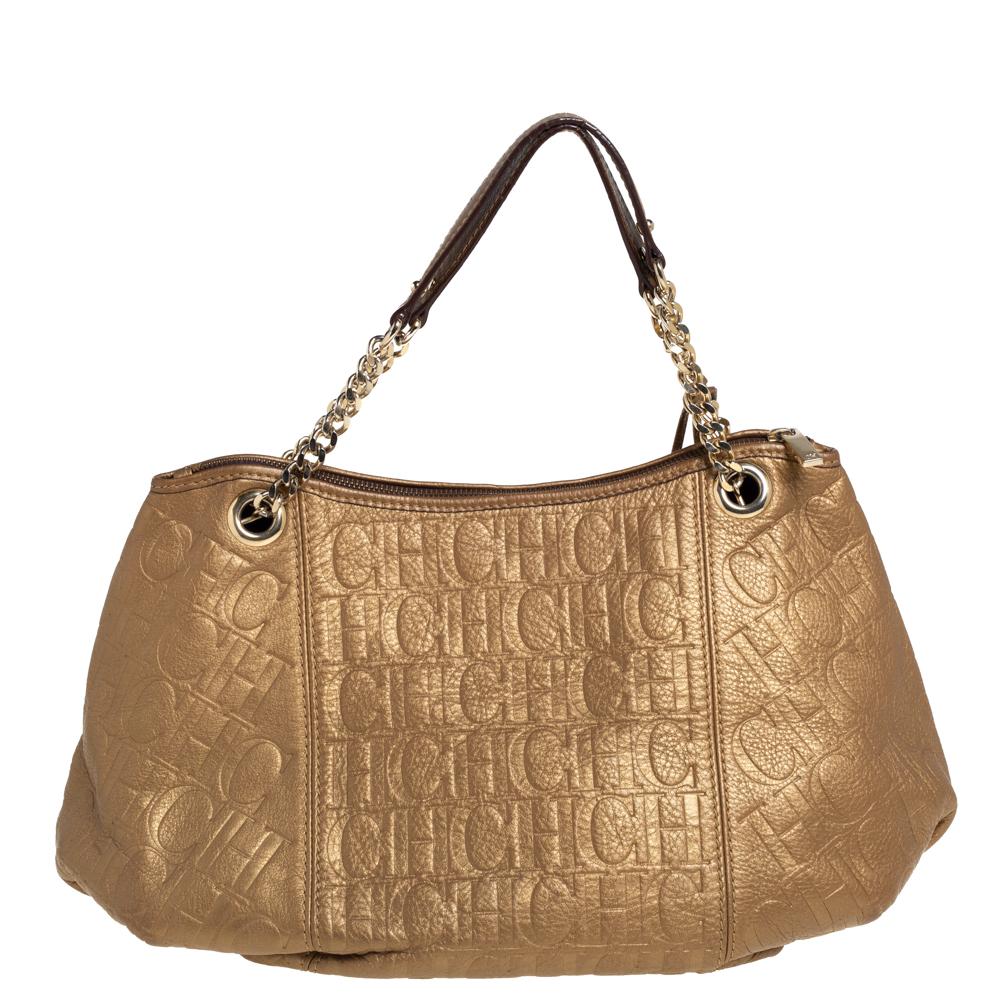 Crafted from golden brown monogram embossed leather, this Carolina Herrera hobo has a style that will catch glances from a mile. It has a slightly slouchy silhouette and opens to a spacious fabric interior. Durable and stylish, it is held by dual