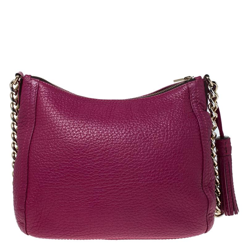 Designed from versatile hot pink leather, this Carolina Herrera bag will go with all your ensembles. It features a leather body secured with a top zipper closure. This bag comes fitted with a chain shoulder strap, a tassel detail and can easily hold
