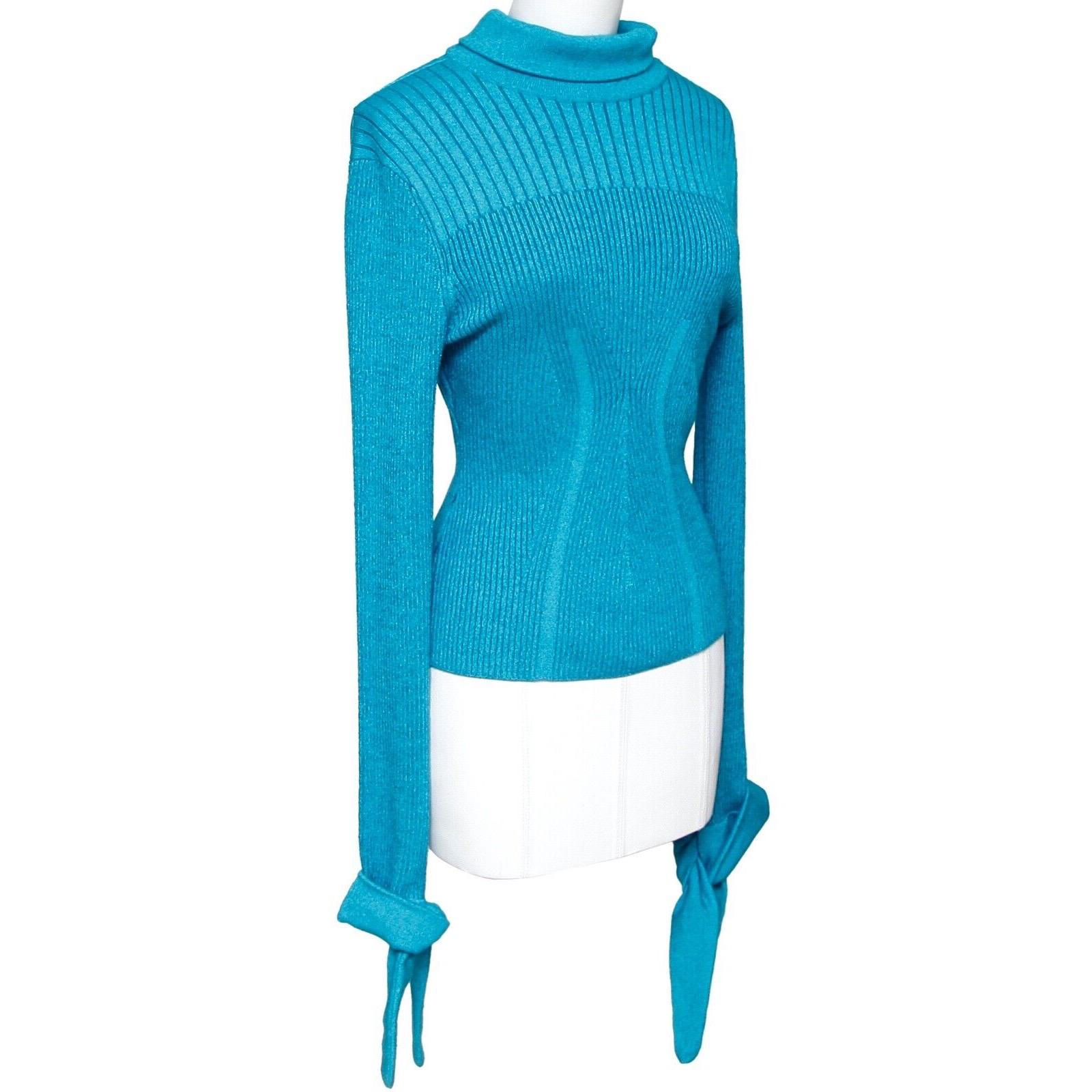 GUARANTEED AUTHENTIC CAROLINA HERRERA BLUE MOCK NECK KNIT SWEATER

Matching Skirt Is Available For Sale In A Separate Listing

Details:
- Blue color.
- Mock neck with sash tie at back.
- Long sleeve with sash tie at wrist.
- Pull on.
-