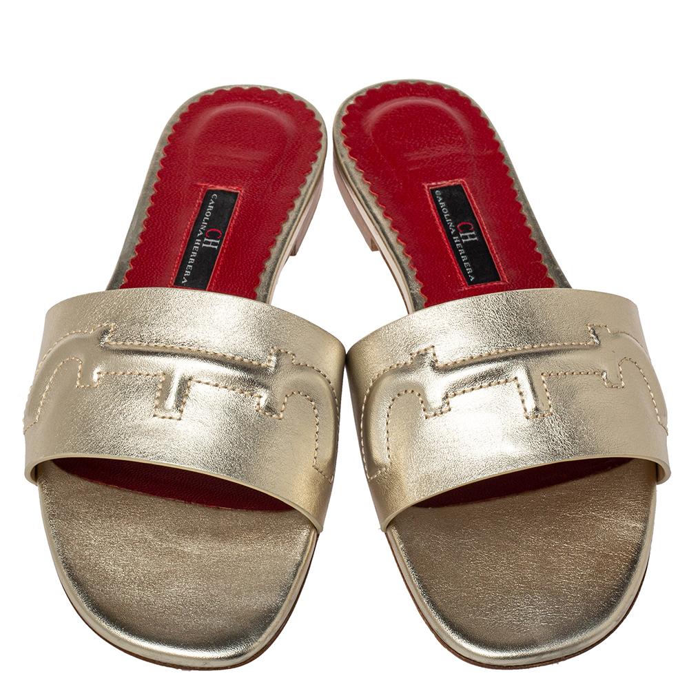 These summer-friendly sandals by Carolina Herrera have been crafted to perfection. Featuring the CH signature on the leather upper and set on a comfortable base, these metallic gold flat sandals will be a delight to wear.

Includes: Original Box,