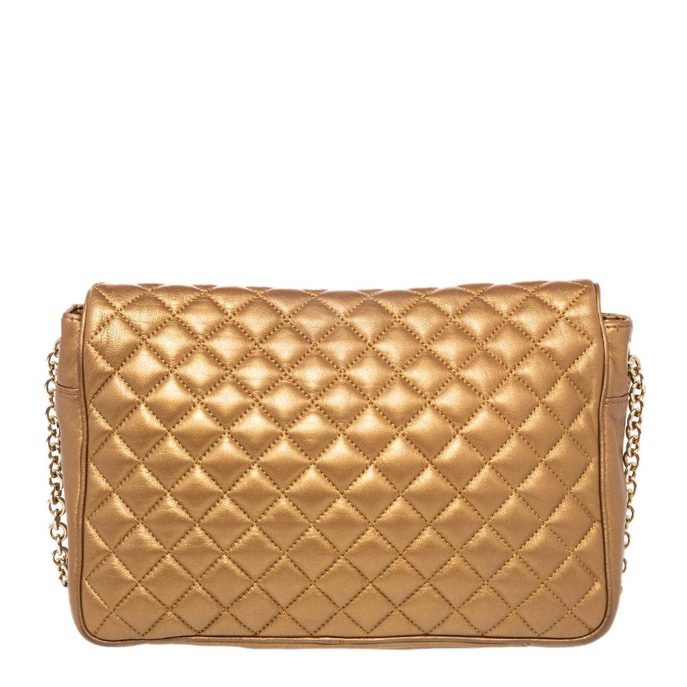 A stylish option for special events is this bag from Carolina Herrera. It is crafted from quilted leather and features a flap design. It has the logo on the front and a fabric-lined interior that is well-sized. The metallic gold bag is complete with