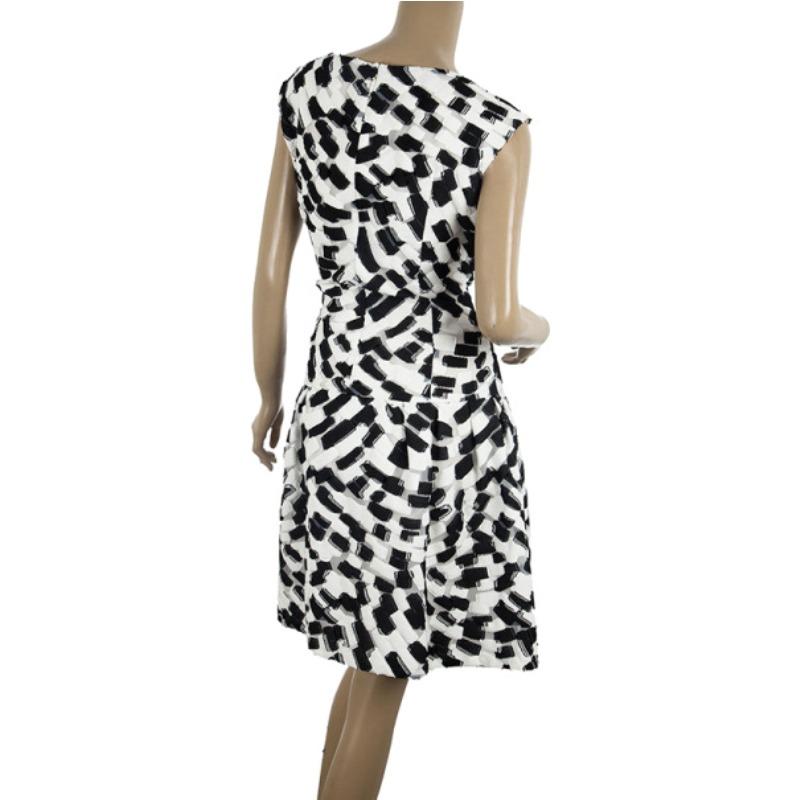 A monochrome print is a timeless trend and this Carolina Herrera dress is simply adorable. This dress has black and white patches on mesh fabric. It features a boatneck, a dropped waist and a zipper fastening at the back.

Includes: The Luxury