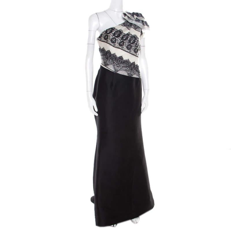This one shoulder evening gown from Carolina Herrera is sure to make you the centre of attraction and grab you never ending compliments! The monochrome creation is made of 100% silk and features a flattering feminine silhouette. It flaunts a lace
