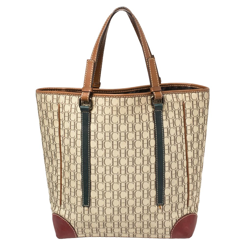 This tote by Carolina Herrera is just what you need to make a statement. Crafted from multicolored Monogram canvas, the stunning bag is enhanced with leather trims. It comes fitted with two handles, brass-tone hardware and a nylon-lined interior.

