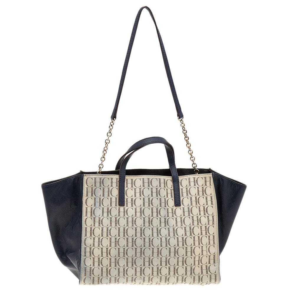 Carolina Herrera brings you this lovely tote that has been crafted from monogram coated canvas as well as leather and detailed with a pocket at the front. It has a well-sized fabric interior, and the bag is completed with two top handles and a