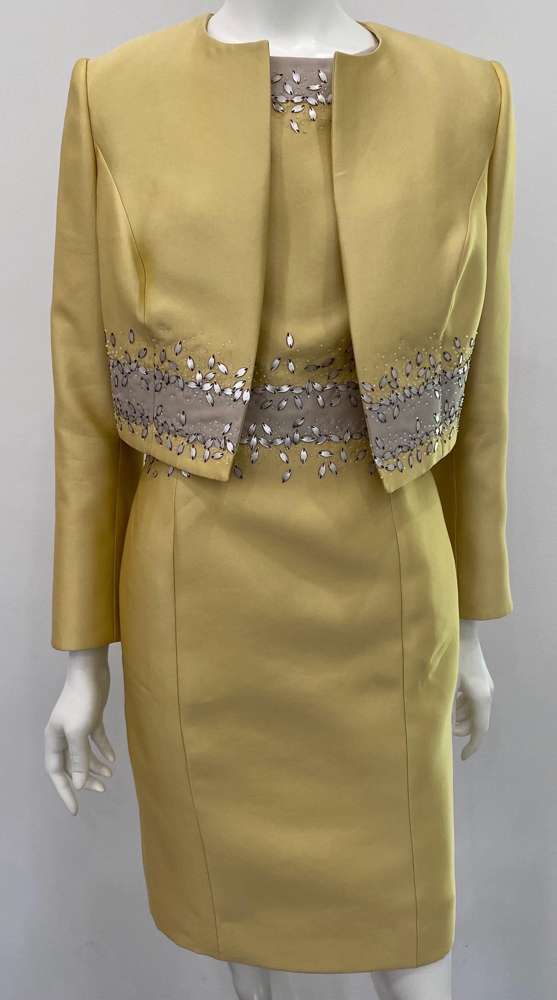 Carolina Herrera Mustard Beaded Silk Sleeveless Dress with Jacket- Sz 10. This very elegant 2 piece ensemble is made of a poly silk blend and is fully lined in silk. The sleeveless sheath dress has a grey trim throughout the neckline, armhole and