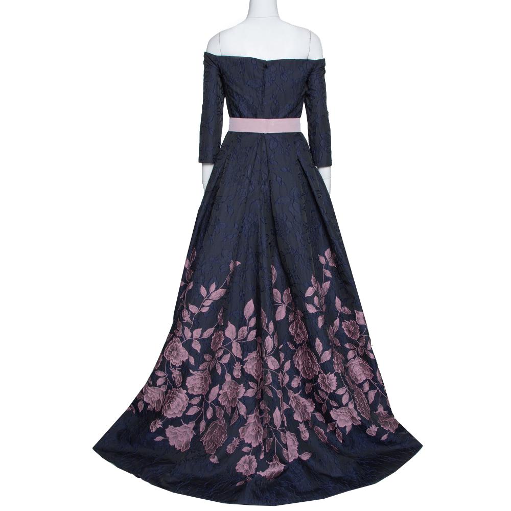 Another dress from Carolina Herrera that's too pretty for words is this one in navy blue. Tailored by experts, the jacquard dress flaunts a subtle off-shoulder design and floral-embroidered, flared skirt. Contrasting belt detail at the waist and a