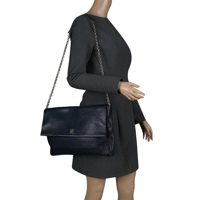 With a suede lined interior, this navy blue bag from Carolina Herrera is in vogue. High on style, it is extremely snug to carry around without compromising on style. This is a classy work essential. Flaunt this fantastic piece of leather and give