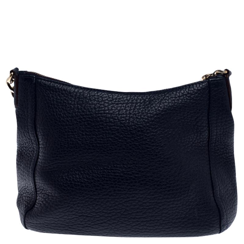 Add an interesting finish to your outfit with this stunning Carolina Herrera Maria shoulder bag. Crafted from pebbled leather in a versatile shade of navy blue, it is accented with a CH metal logo, a top zip closure and a comfortable chain shoulder