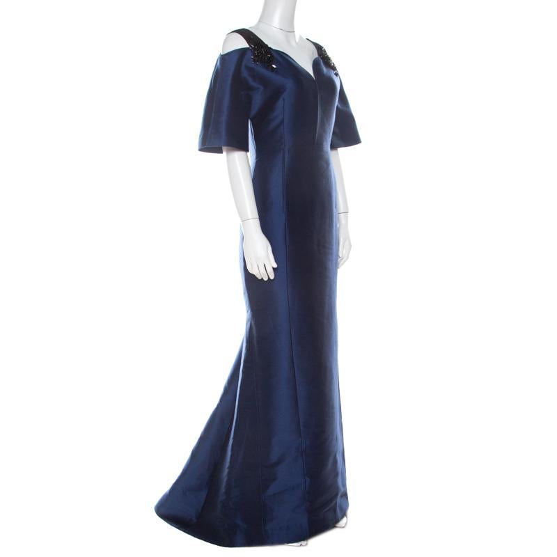 We've fallen in love with this gorgeous evening gown from the house of Carolina Herrera! The lovely navy blue creation is made of a cotton and silk blend with soft silk lining and features bejewelled straps on the shoulders. It flaunts a plunging