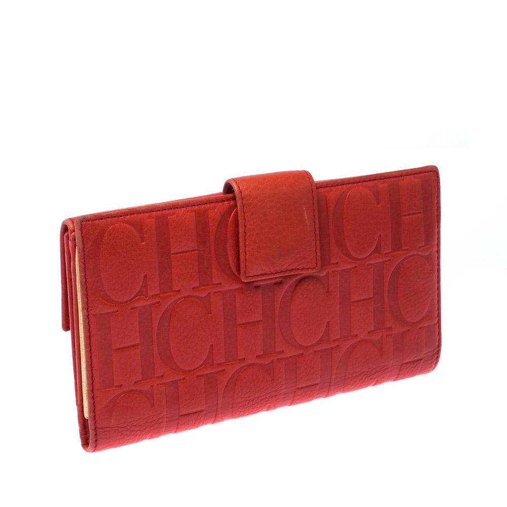 Stylish wallets are a must-have! This flap wallet from the house of Carolina Herrera is crafted from leather and features the signature CH embossed all over its exterior. Styled as a single fold with a flap, the wallet is equipped with multiple