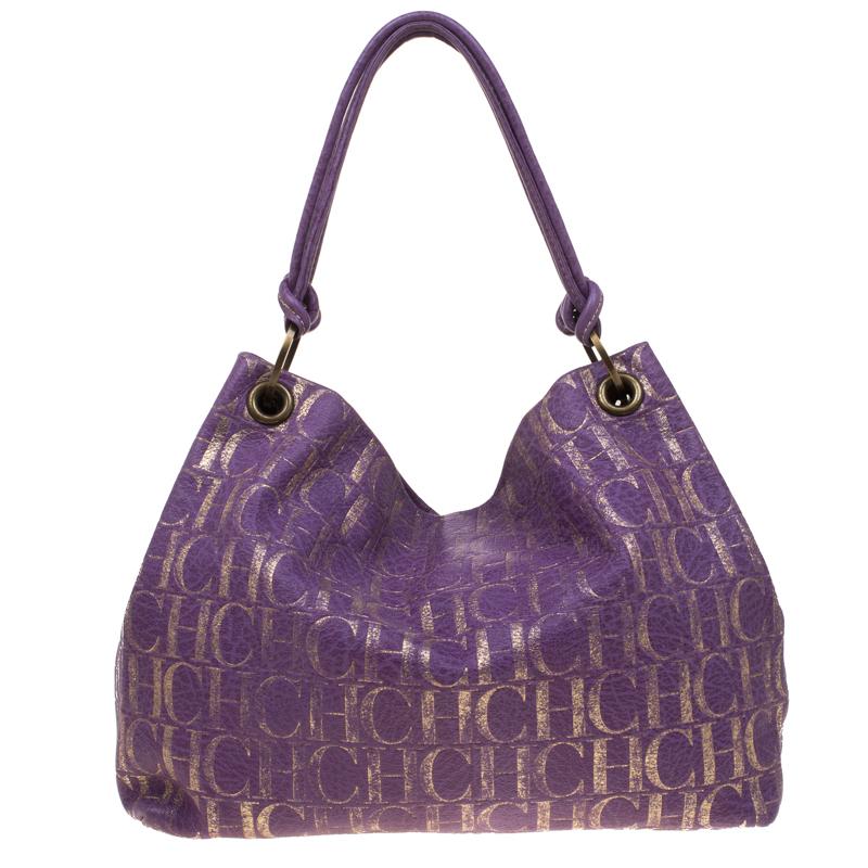 Crafted in a purple leather body, this Carolina Herrera shoulder bag features the iconic 'CHCH' logo in gold all over. It comes with an open top and is fitted with a knotted shoulder strap. The fabric-lined interior of this bag is spacious enough to