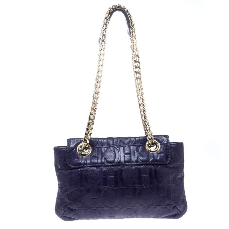 This Audrey bag from Carolina Herrera is styled with a bow detail on the front. It is crafted with signature monogram leather in a pretty purple color and a flap top that leads to a fabric-lined interior with a side zip pocket. The bag also features