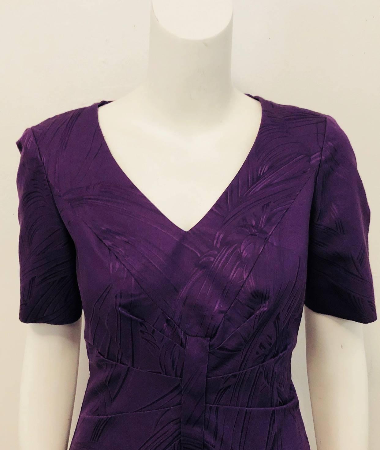 This Carolina Herrera purple brocade sheath dress is an exquisite dress for many occasions,  you could say a dress for all seasons!   With its V neckline, short sleeves and gathered bodice, this dress follows the House of Herrera distinctive
