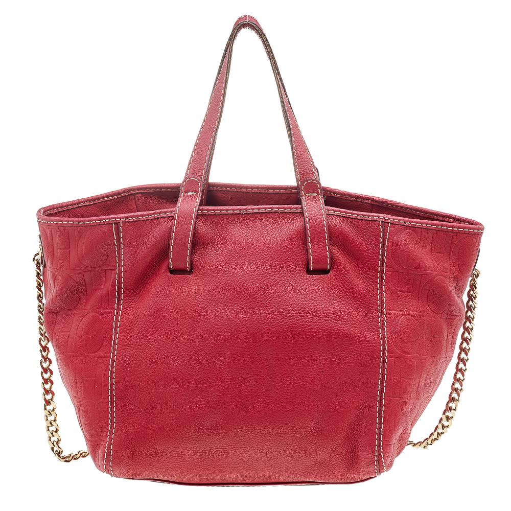 Designed from leather, this Carolina Herrera tote in red will complement your everyday look. It features monogram-embossed sides, flat top handles, a chain shoulder handle, and a spacious interior.

Includes: Original Dustbag