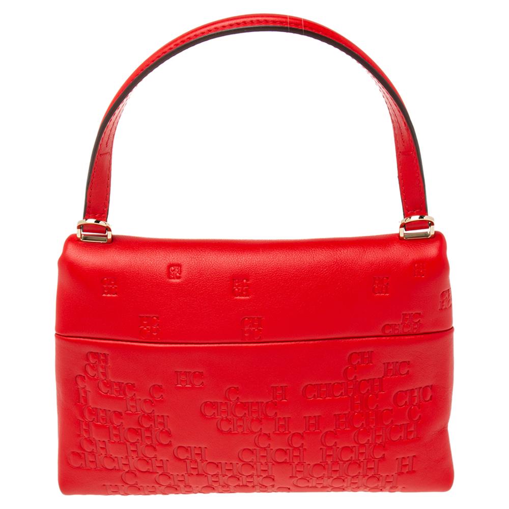 This Camelot bag from the House of Carolina Herrera is great to appear stylish and trendy! It is made from red Signature -embossed leather on the exterior. It has a neat canvas-suede interior, gold-tone hardware, and a top handle. This stunning bag