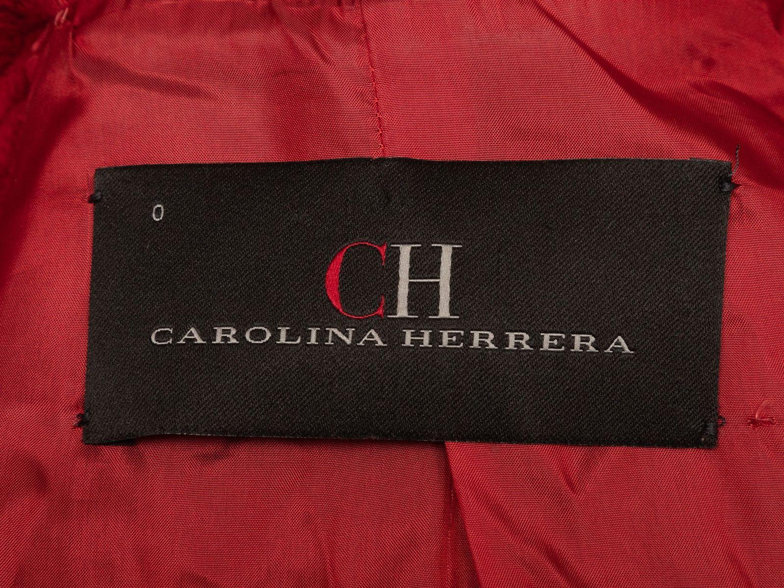 Product Details: Red wool textured double-breasted coat by Carolina Herrera. Pointed collar. Button closures at front. 31