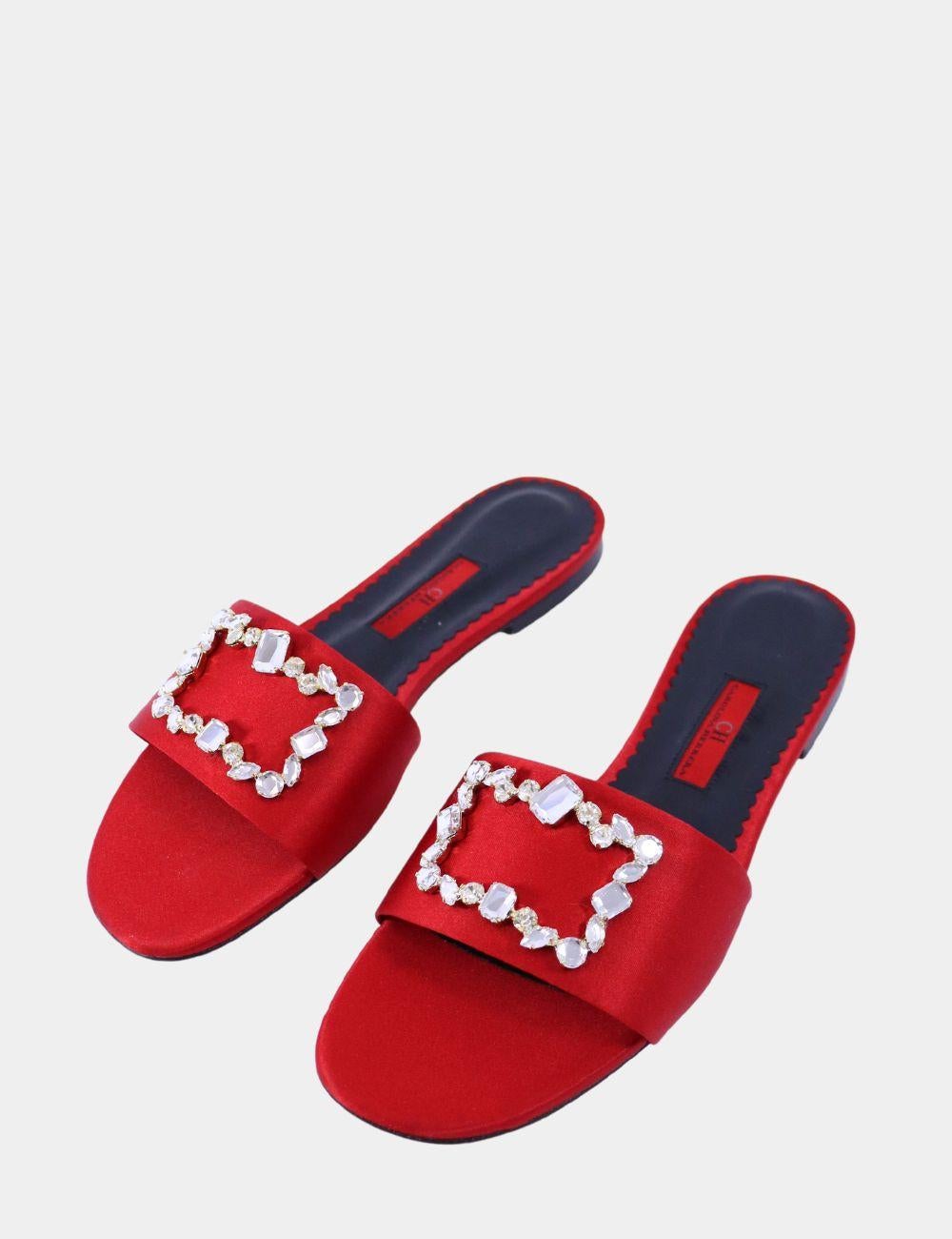 Step into glamour with these stunning Carolina Herrera red satin slides, adorned with an eye-catching crystal-embellished buckle. Crafted from luxurious satin in a bold red hue, these slip-on sandals feature a comfortable flat sole and a chic open