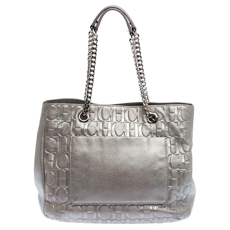 Bags as pretty as this one by Carolina Herrera are not creations you find every day. That's why this bag is worthy of a place in your closet. It has been crafted from leather and styled with a bow-adorned on the front. It has a well-sized