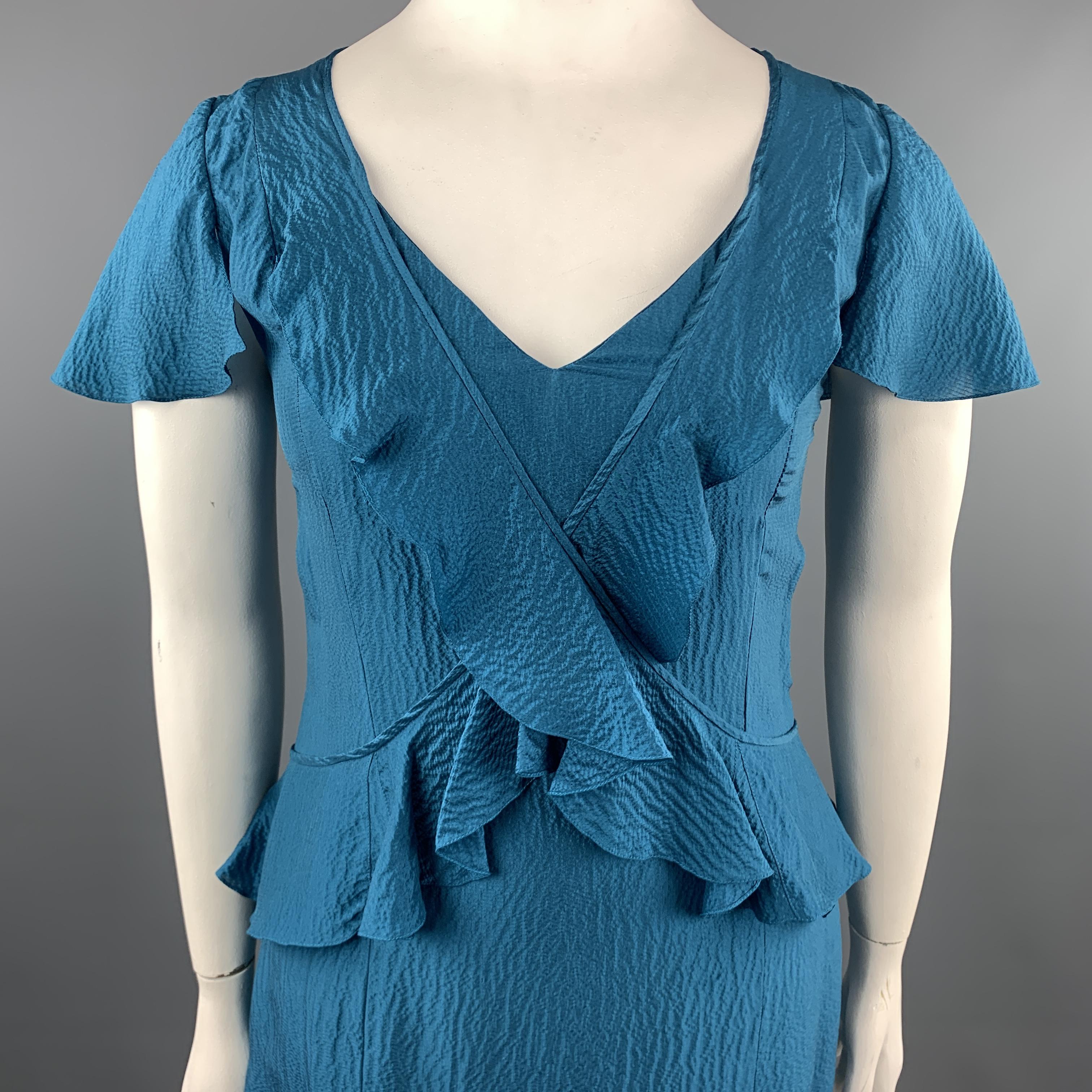CAROLINA HERRERA dress comes in teal textured satin with a V neck, short sleeves, pleat ruffle hem, and cross ruffle overlay. 

Excellent Pre-Owned Condition.
Marked: 12

Measurements:

Shoulder: 17 in.
Bust: 38 in.
Waist: 34 in.
Hip: 42 in.
Sleeve: