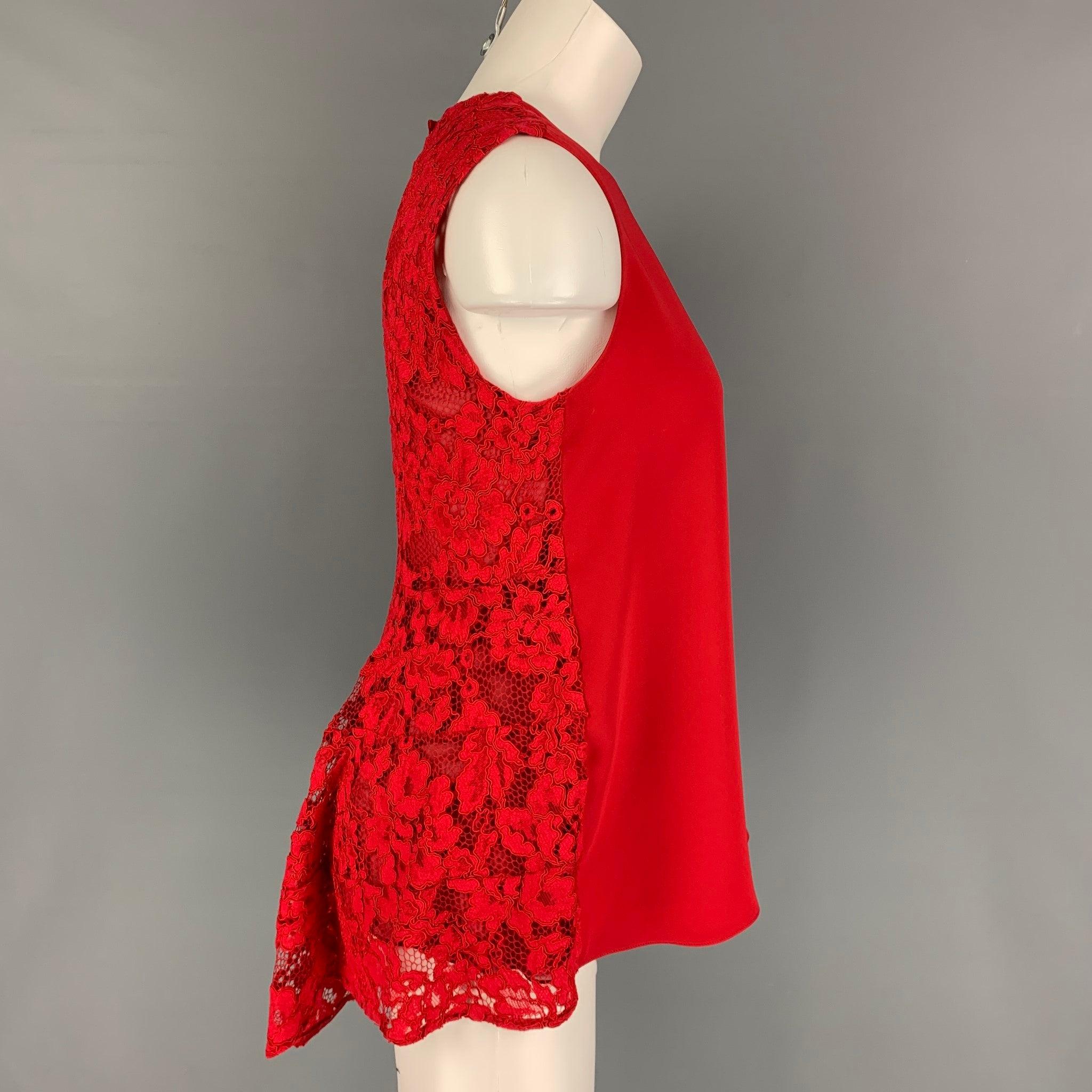 CAROLINA HERRERA blouse comes in a red polyester blend featuring a peplum style, back lace panel, and a single button closure.
Very Good
Pre-Owned Condition. 

Marked:   2 

Measurements: 
 
Shoulder: 14.5 inches  Bust: 32 inches  Length: 28 inches