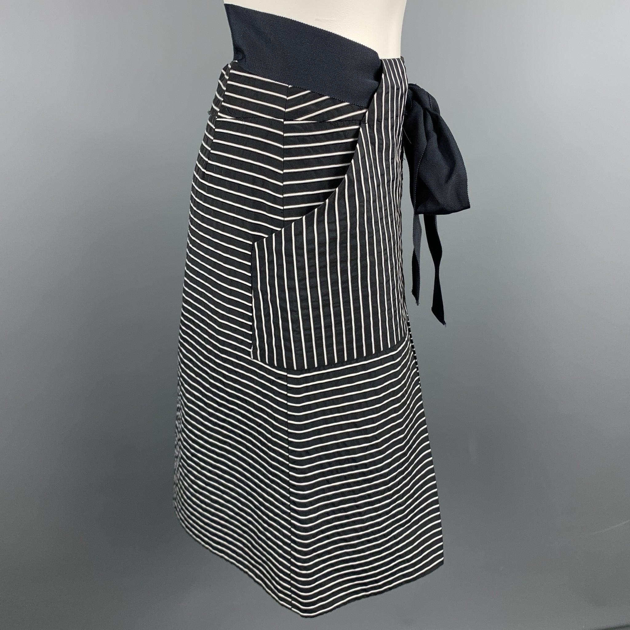 CAROLINA HERRERA skirt comes in a black & white stripe cotton / polyester featuring an a-line style, ribbon belt, and a back zip up closure.
Excellent
Pre-Owned Condition. 

Marked:   2 

Measurements: 
  Waist: 26 inches 
Hip: 36 inches 
Length: 21