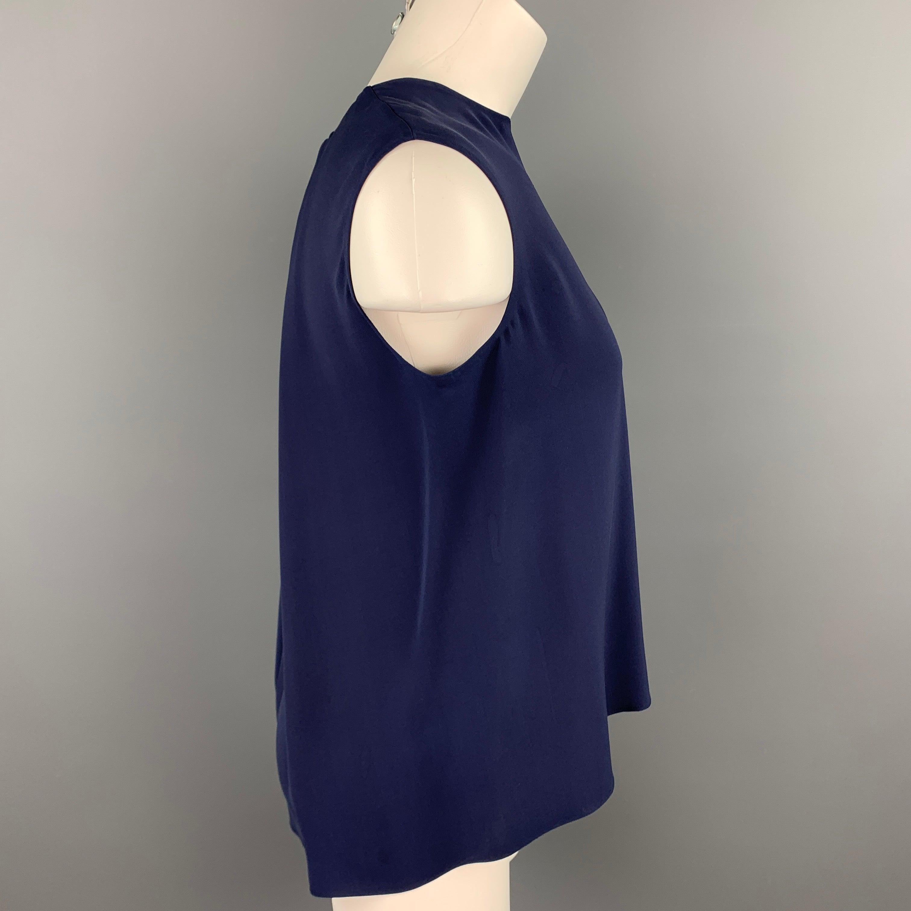 CAROLINA HERRERA sleeveless blouse comes in a navy silk featuring an asymmetrical hem and a back zip up closure.
Good
Pre-Owned Condition. 

Marked:   4 

Measurements: 
 
Shoulder: 15 inches  Bust: 36 inches  Length: 24.5 inches 
  
  
 
Reference: