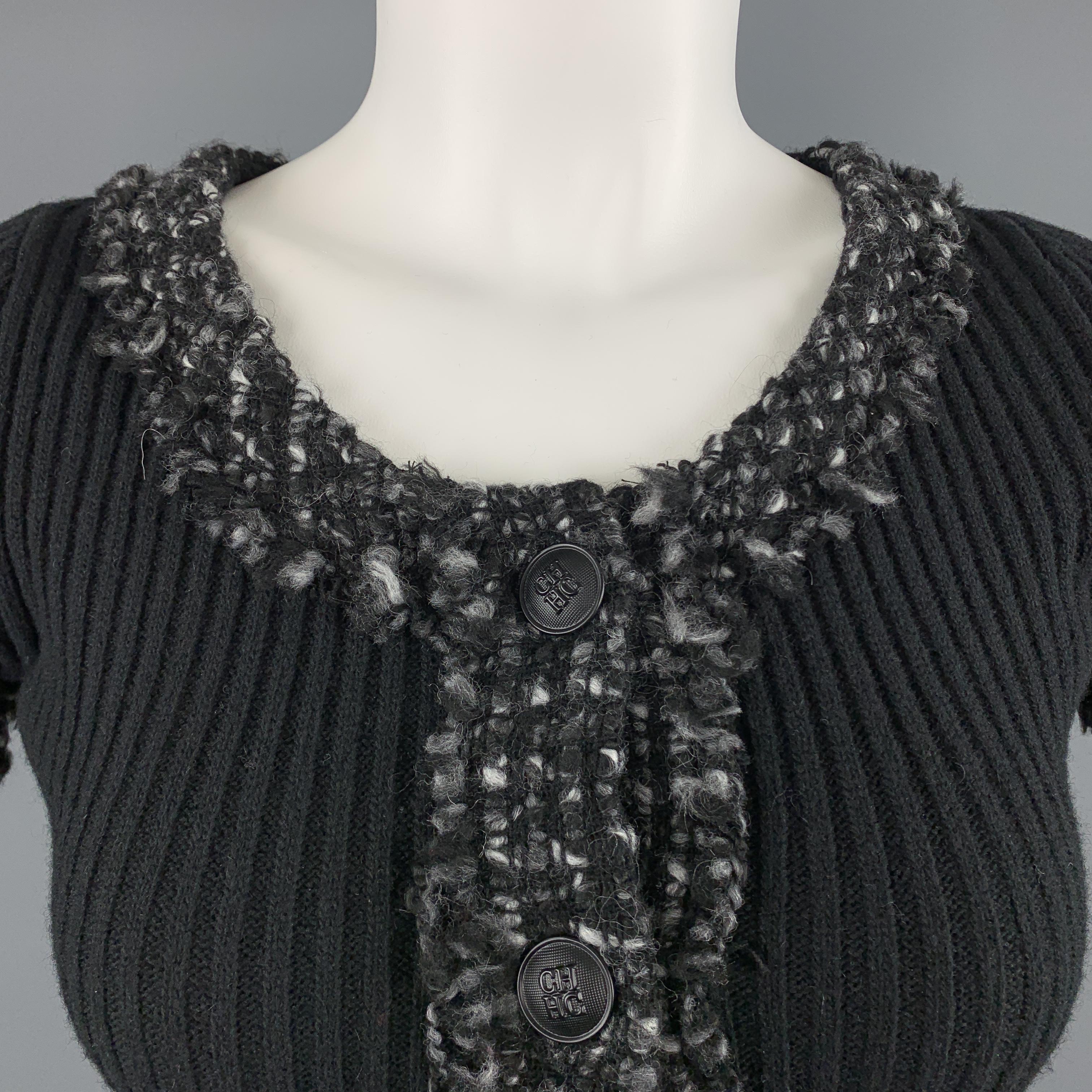 CAROLINA HERRERA pullover sweater comes in black ribbed knit with a round neckline, half button front, and gray tweed knit trim. Made in Spain.

Excellent Pre-Owned Condition.
Marked: XS

Measurements:

Shoulder: 12 in.
Bust: 32 in.
Sleeve: 7