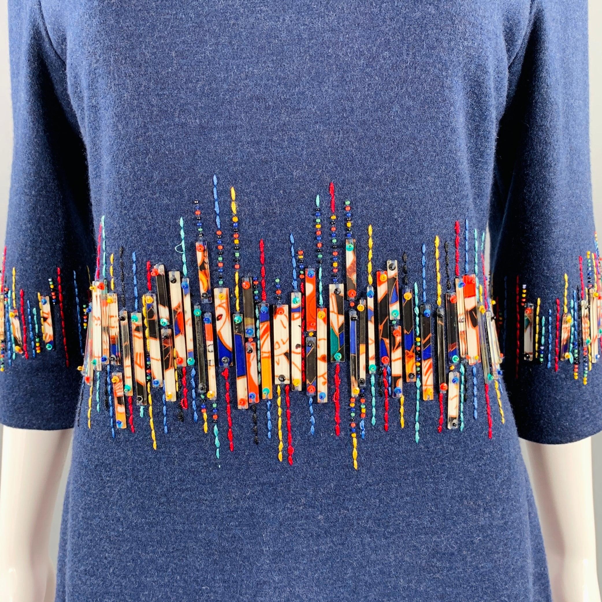 CAROLINA HERRERA Pre-Fall 2010 dress
in a blue wool featuring multi-color beading and embroider around the middle and sleeves, 3/4 sleeves, and back zipper closure.Very Good Pre-Owned Condition. Minor signs of wear in beading. 

Marked:   6