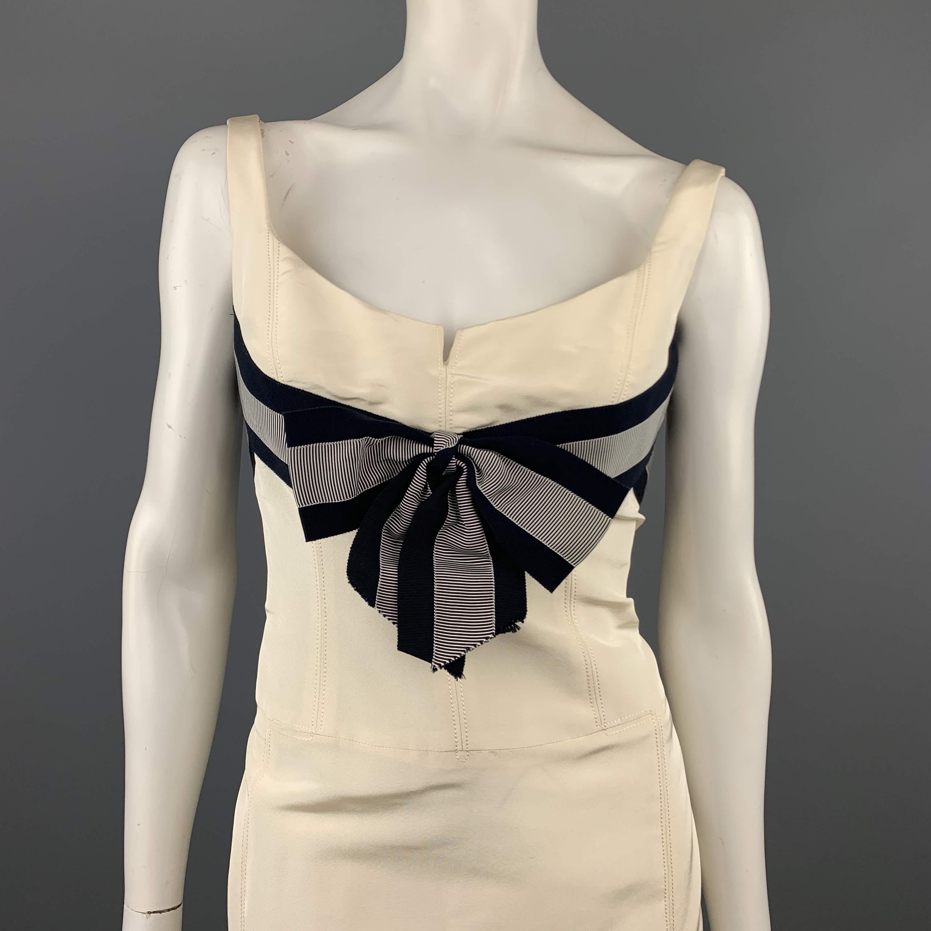 CAROLINA HERRERA cocktail dress comes in cream silk faille with a sleeveless sweetheart neckline navy striped ribbon bow accent, and flaired skirt. Made in USA.
 
New with Tags.Pre-Owned Condition.
Marked: 6
 
Measurements:
 
Shoulder: 13 in.
Bust: