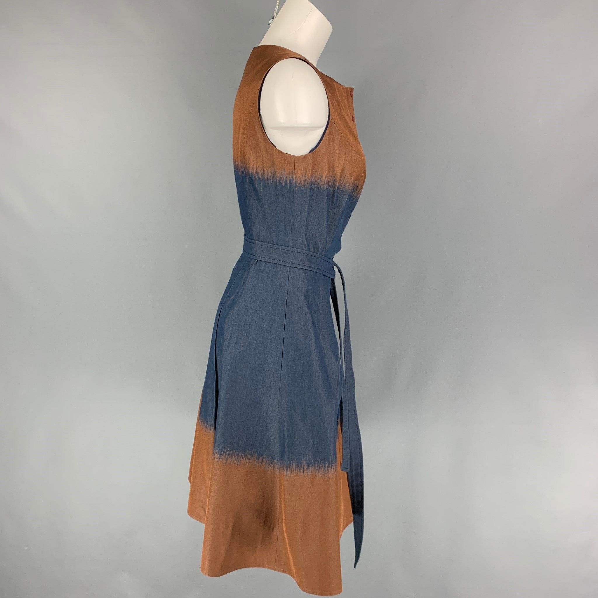 CAROLINA HERRERA dress comes in a navy & brown ombre cotton blend featuring an a-line style, belted, pleated, sleeveless, and a front buttoned closure. Made in USA.
Very Good
Pre-Owned Condition. 

Marked:   8 

Measurements: 
 
Shoulder: 13.75