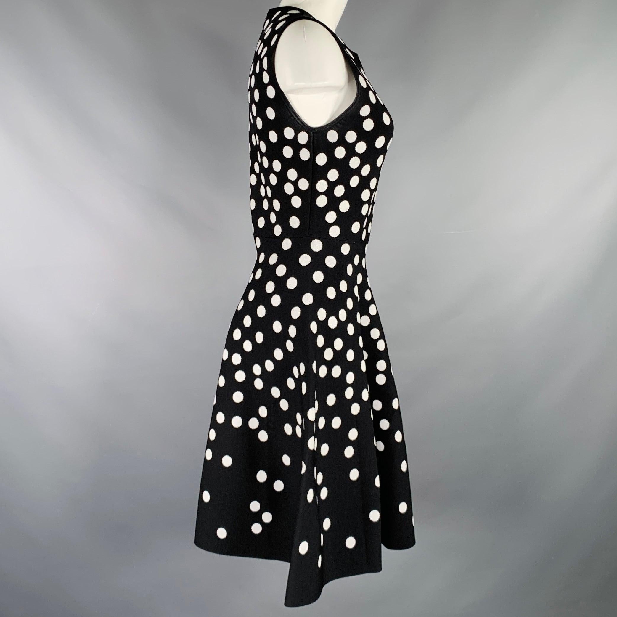 CAROLINA HERRERA dress
in a black and white viscose knit featuring an A-line style, polka dot pattern, and invisible back zipper closure.Very Good Pre-Owned Condition. Mark under arms. 

Marked:   M 

Measurements: 
 
Shoulder: 13.5 inches Bust: 32
