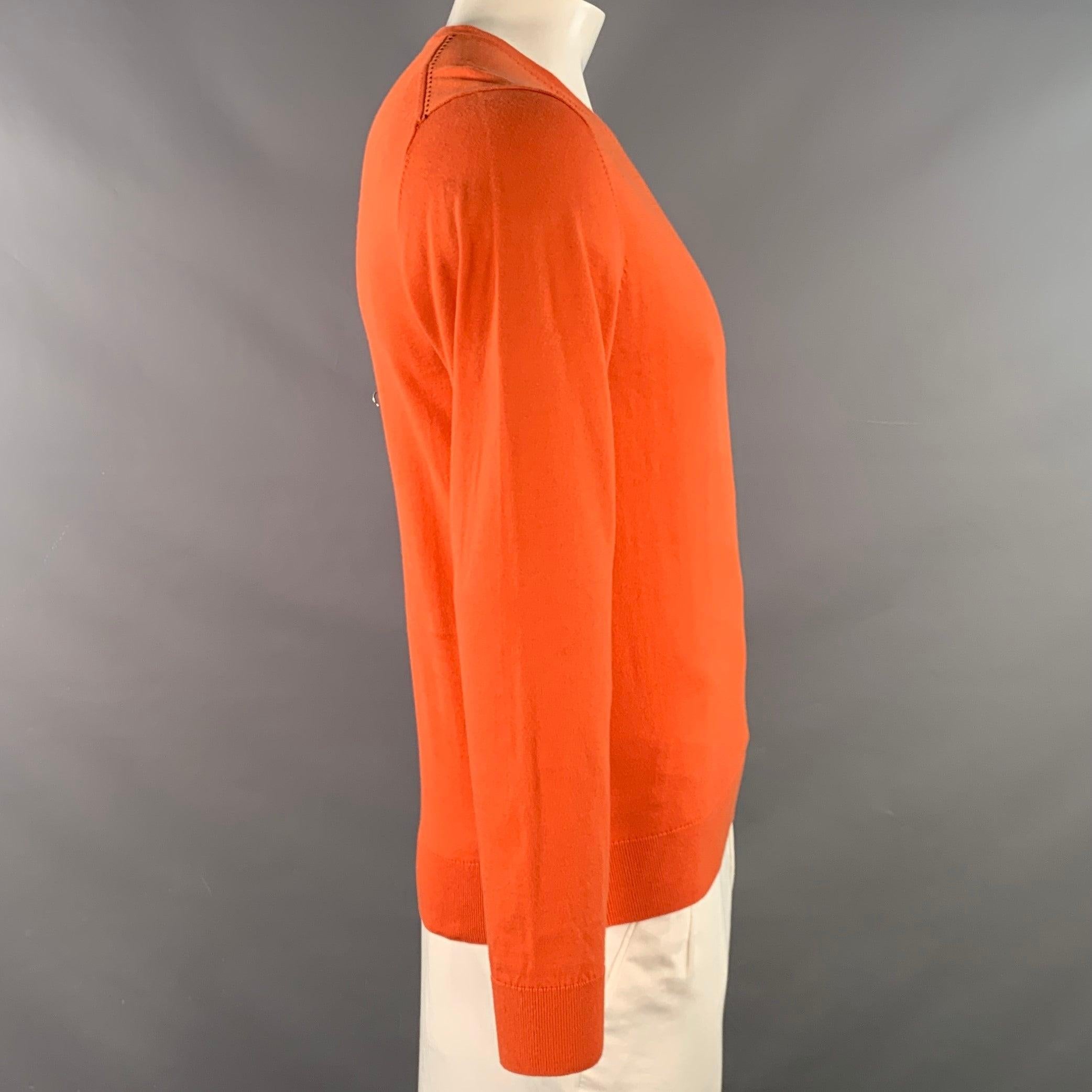 CAROLINA HERRERA pullover
in an orange cotton knit featuring long sleeves and V-neck.Very Good Pre-Owned Condition. Tiny, hard-to-see marks. 

Marked:   M 

Measurements: 
 
Shoulder: 18 inches Chest: 41 inches Sleeve: 25.5 inches Length: 26 inches