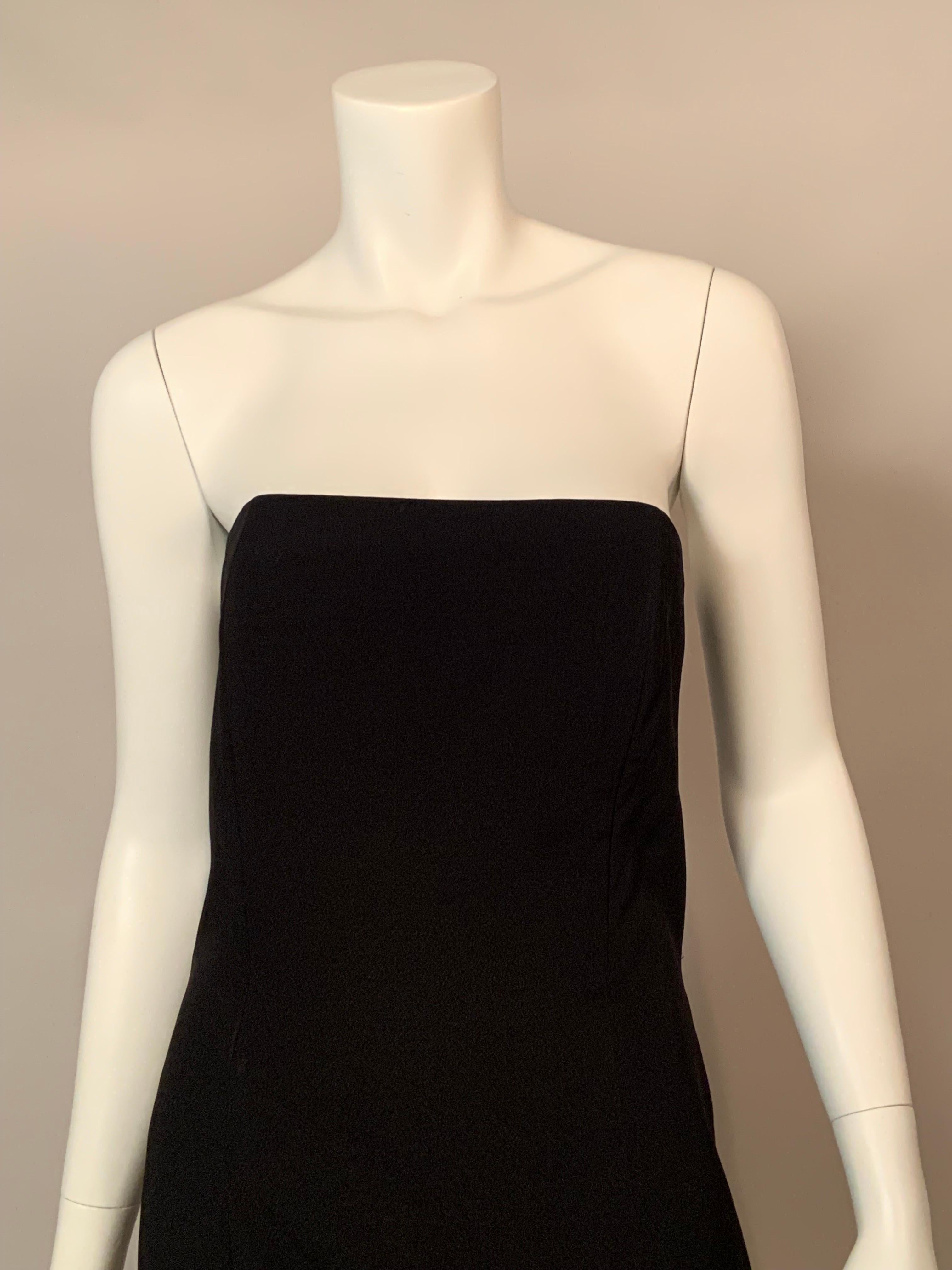 Carolina Herrera Has designed a classic strapless evening dress with a boned bodice and a slightly flared skirt below the knee. This piece was a sample from her CH line. This dress is a perfect base for accessories or glamorous jewelry. It has a