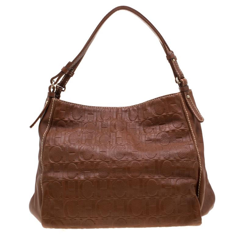 Flaunt an astonishing style with this amazing leather bag. The fine fabric-lined spacious interior. Turn heads when you go out carrying this beautifully crafted arm candy from Carolina Herrera. Every fashion connoisseur needs a tan handbag just like