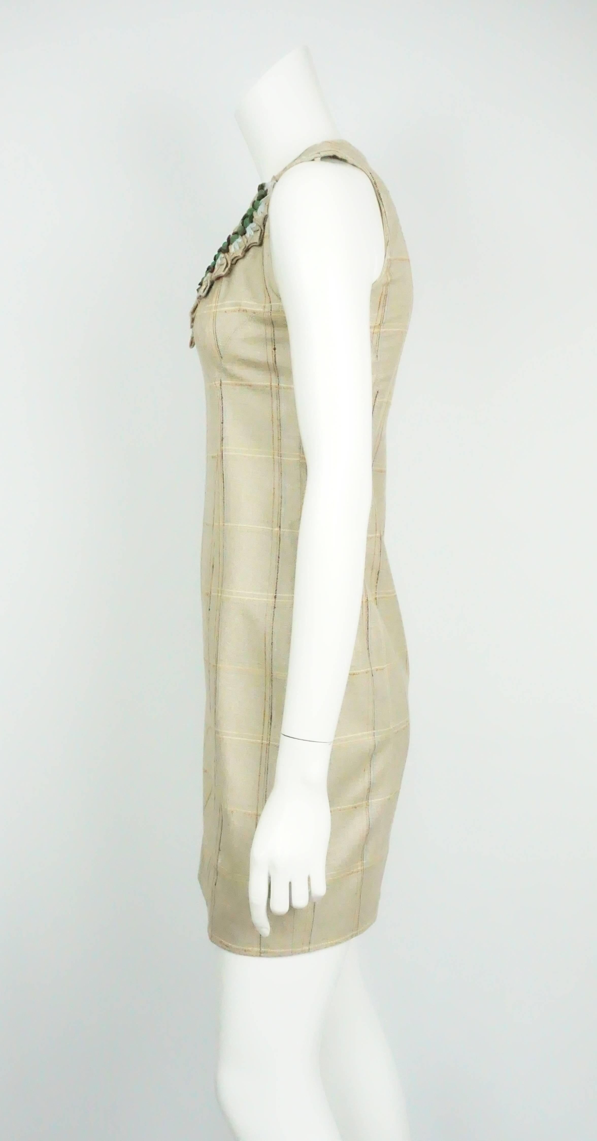 Carolina Herrera Tan Plaid Dress w/ Stone Detail - 2 This classic sheath dress is completely made of silk. It is sleeveless and hits right above the knee. It has a plaid pattern throughout with a beautiful scoop neck detailing that includes a braid