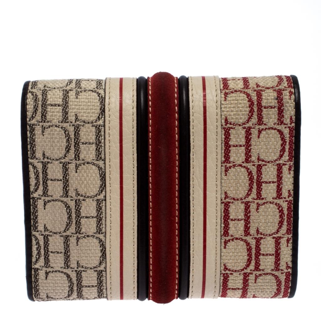 Designed to perfection and crafted from signature canvas, suede and leather, this wallet can be your go-to accessory. This trifold wallet is a handy creation from the house of Carolina Herrera. The flap detail on this stylish wallet adds to the