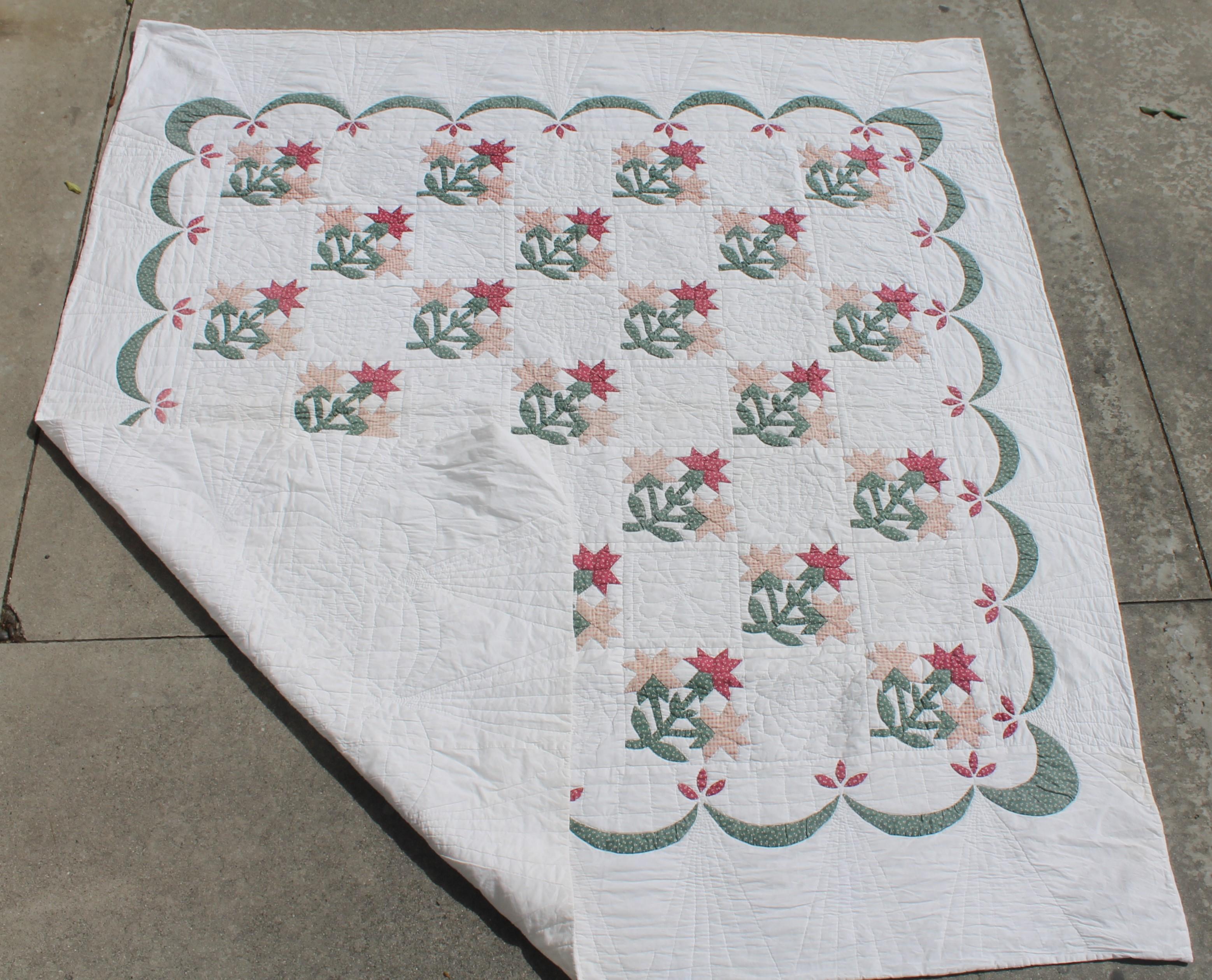 This fine late but great Carolina Lilly applique quilt is in fine condition with a wonderful swag border. The quilting and piecework is very good.