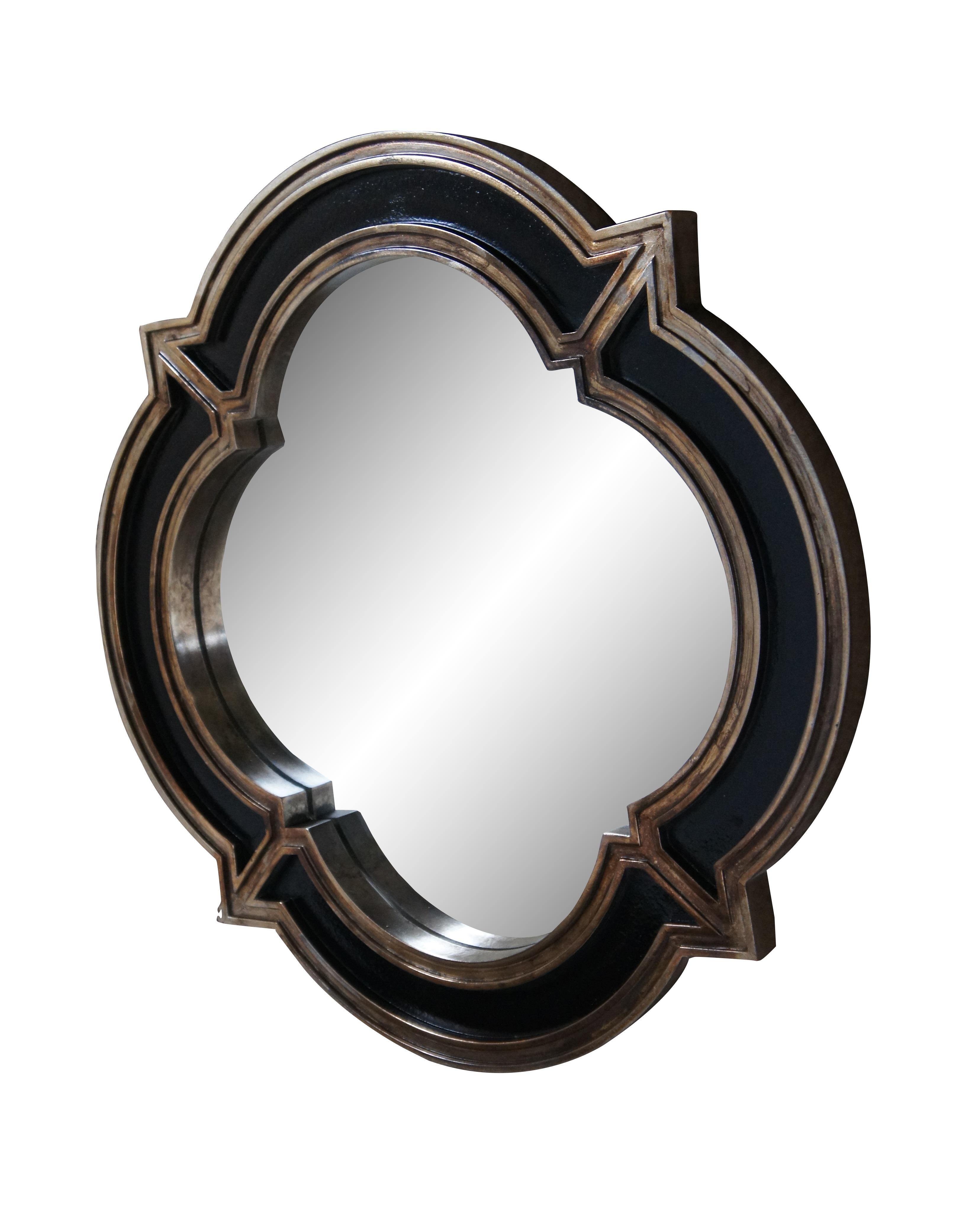 Vintage wall hanging mirror by Carolina Mirror company for Crown Fine Arts, featuring an elegant quatrefoil shape in black with burnished champagne gilt borders. Hand marked 11703 – 49440 on back.

Dimensions:
23.75” x 1.25” x 23.75” (Width x Depth