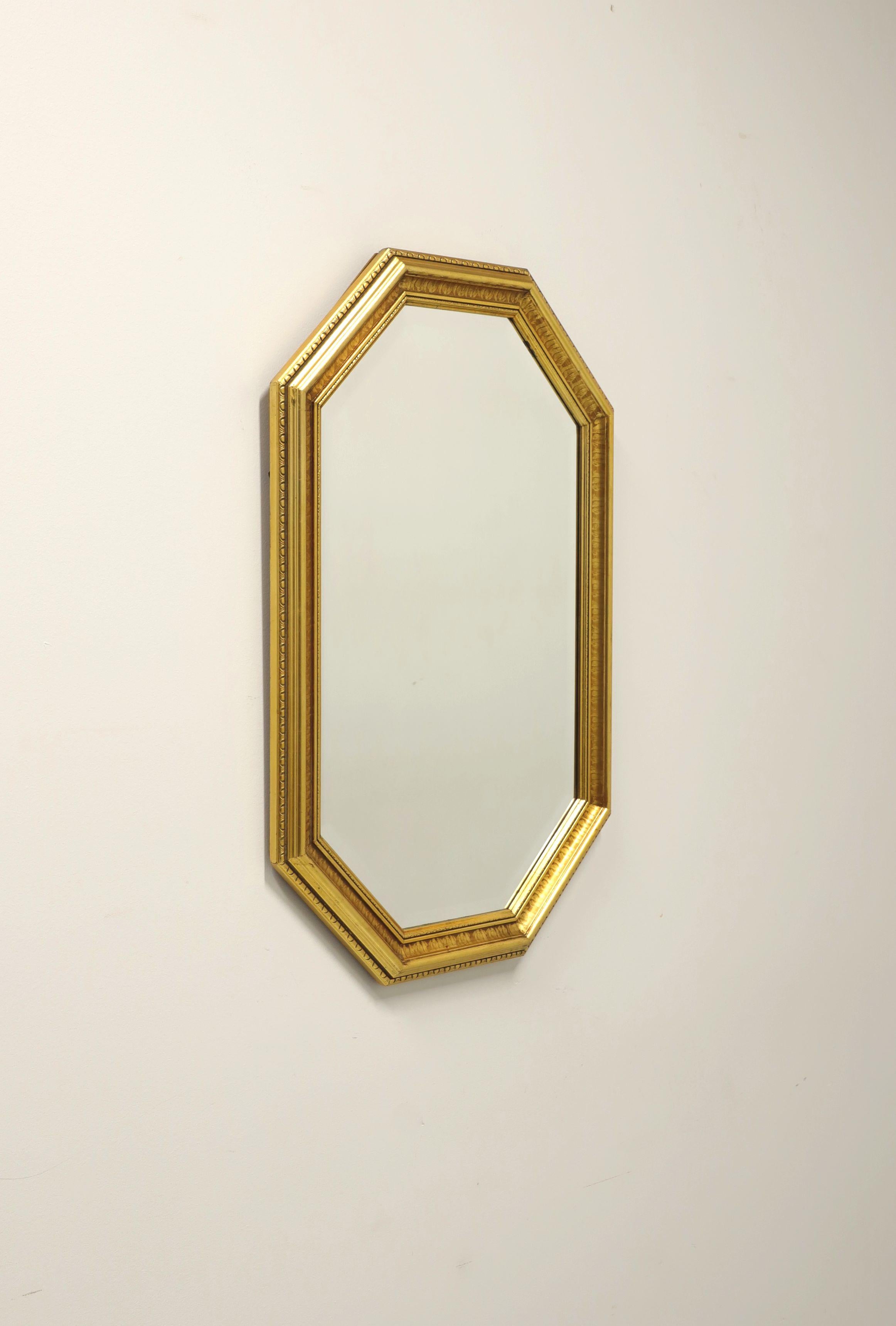 A Traditional style wall mirror by Carolina Mirror. Beveled mirror glass and gold painted solid wood frame. Features an octagonal shape with decorative detail to frame. Made in North Carolina, USA, in the late 20th Century.

Measures: 31 W 1 D 50.25