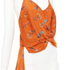 CAROLINE CONSTAS 2018: camisola corta de seda con estampado floral naranja, con efecto retorcido y corte asimétrico, talla M