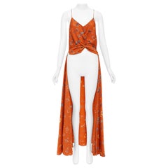 CAROLINE CONSTAS 2018: camisola corta de seda con estampado floral naranja, con efecto retorcido y corte asimétrico, talla M